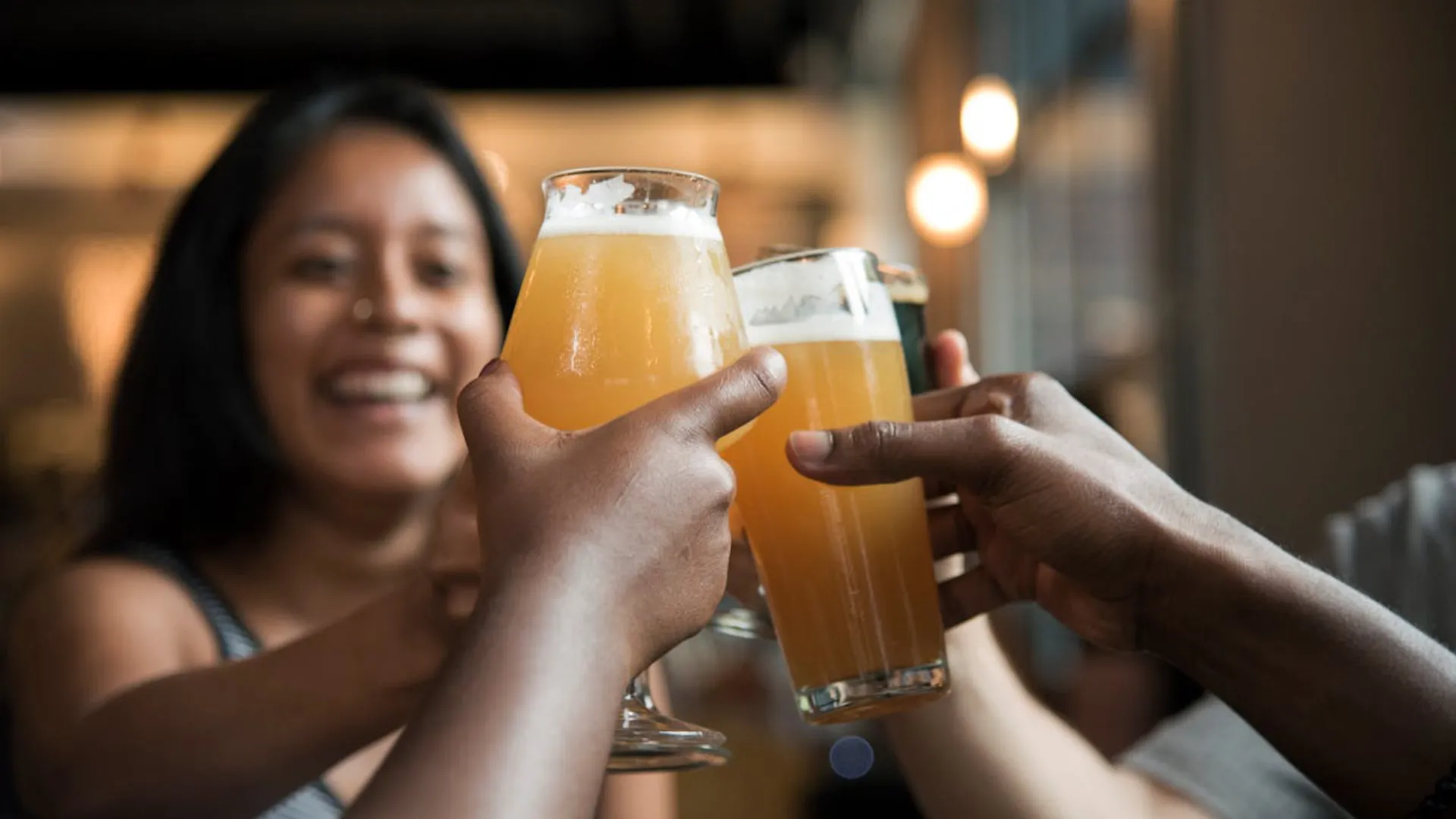 Image of a woman holding a glass of beer